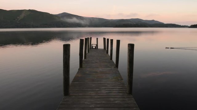 Lake Derwent water and Ashness jetty in English lake district at sunrise.