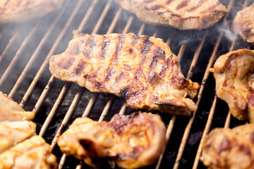delicious grilled meat over the coals on a barbecue