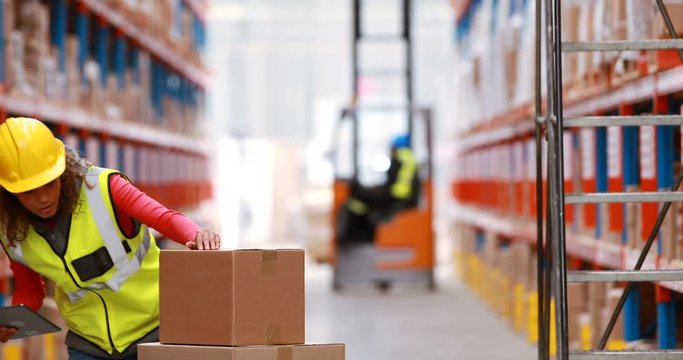 Female warehouse worker using digital tablet