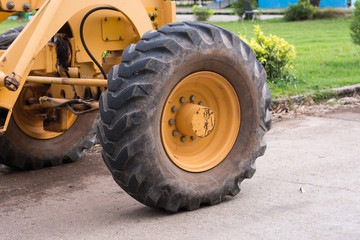 Fototapeta na wymiar big wheel on yellow tractor