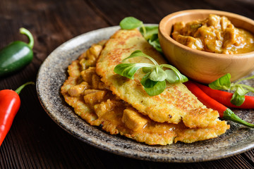 Pork meat with chili sauce in a potato pancake