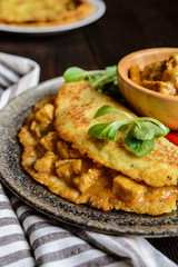 Pork meat with chili sauce in a potato pancake