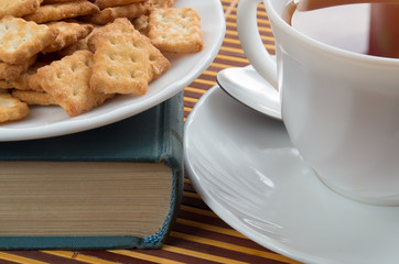 Detail of a cup of tea and a plate of crackers