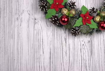 Fototapeta na wymiar Part of Christmas wreath on a white wooden background