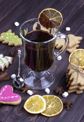 Xmas mulled wine in a glass with dried oranges christmas cookies