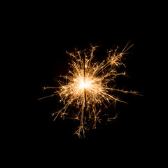 Burning sparkler isolated on black background