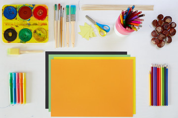 Artistic tools on white small table for children.