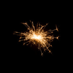 Burning sparkler isolated on black background