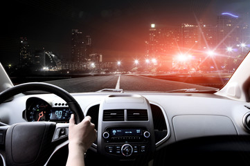 Drivers hands on steering wheel inside of a car