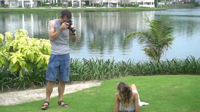 Beautiful model posing for male photographer during outdoor photo shoot