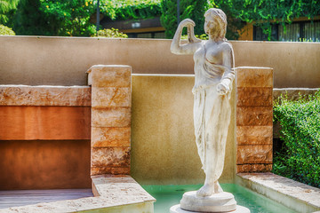 Female statue made of marble. Decorative gardens
