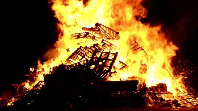 Closeup of wooden pallets burning in a bonfire.