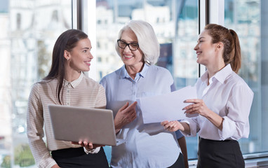 Young colleagues and their boss laughing together in an office