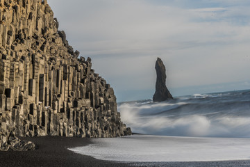 Reynisdranger, basalt sea stacks with the wave and black sand beach near the small village Vik i Myrdal in the south of Iceland