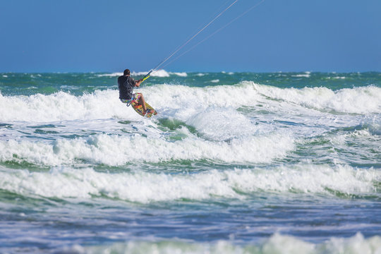 Wan riding kite surf on sea waves