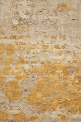 Brick Wall With Damaged  Shabby Yellow Plaster Vertical Backgrou