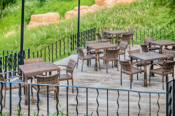 The wood table on natural outdoor of a restaurant with tree and