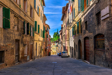 Fototapeta na wymiar Medieval narrow street in Siena, Tuscany, Italy