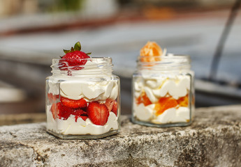 Dessert cream with strawberries and mandarin in jar