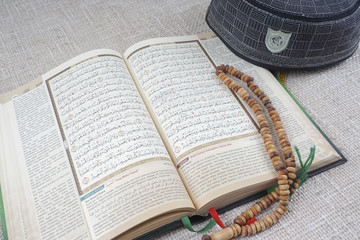 Rosary, quran isolated on wooden table. - 127758403