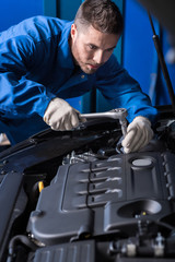 Professional mechanic repairing break out in service center