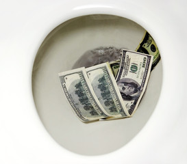 Flushing money down the toilet. Horizontal