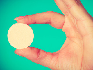 Woman hand holding big effervescent pill