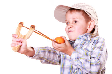 Young boy use sling shot shoot mandarine.