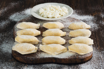 Lots raw dumplings with cottage cheese