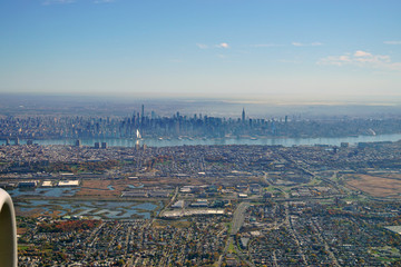 Obraz na płótnie Canvas Aerial view of the Manhattan skyline in New York City seen from an airplane in approach for landing at Newark Liberty International Airport (EWR)