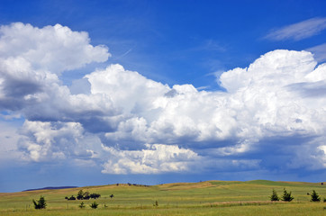 Beautiful cloudscape over rolling green hills and farmland in the New South Wales countryside, Australia
