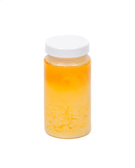 Clarified butter ghee in plastic jar isolated on white background