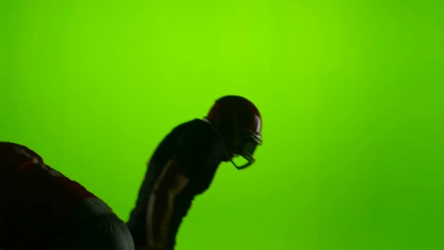Two football players face each other. Slow motion. Green screen