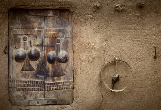 Tireli, Mali, Africa - January 30, 1992: Dogon village and typical mud buildings, typical handmade window on wood
