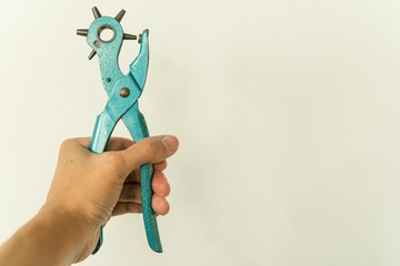 Leather Hole Punch Tool in handhold on copy space background - hole punch for leather goods Old...
