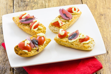 Tasty appetizer of canapes and vegetables