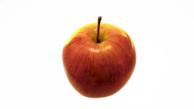 Apple suspended in the air rotates in loop 