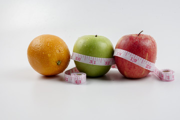 apple, orange and measuring tape. Healthy life concept.