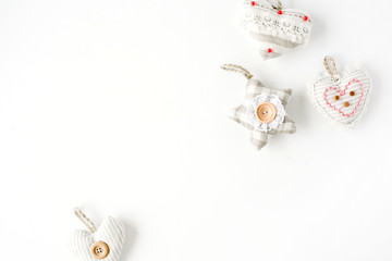 creative arrangement of handmade knitted christmas toys on white background. flat lay, top view