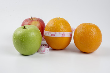 apple, orange and measuring tape. Healthy life concept.