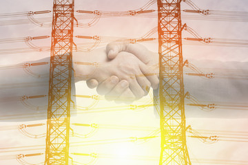 Double exposure of handshake and High voltage pylon with sunset.