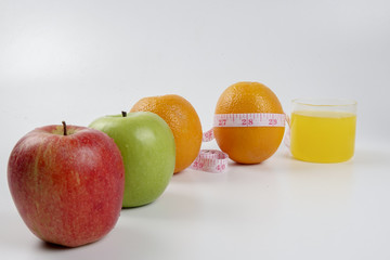 apple ,orange and measuring tape. Lifestyle concept.