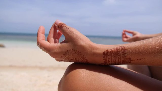 Female Hand with Yoga Gesture Called Guyan Mudra on Beach