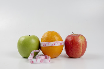 apple ,orange and measuring tape. Lifestyle concept.