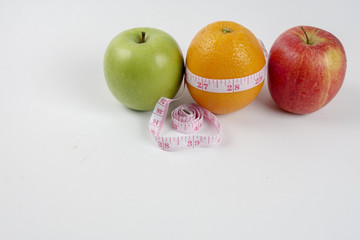 apple ,orange and measuring tape. Lifestyle concept.