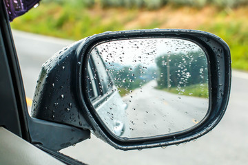 Landscape in the sideview mirror of a car, on road countryside, natural