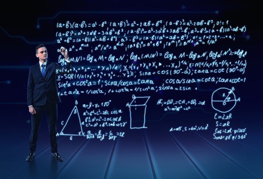 Man in a suit full-height writing lot of trigonometrical formulas in the air
