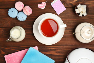 Tea set on wooden background, flat lay