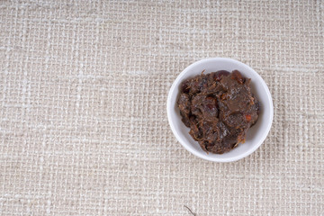 Tamarind paste on small bowl.