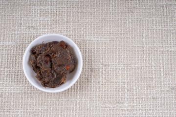 Tamarind paste on small bowl.